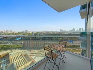 d'une table et de deux chaises sur un balcon avec vue. dans l'établissement Spacious 1BR APT Wasl, à Dubaï