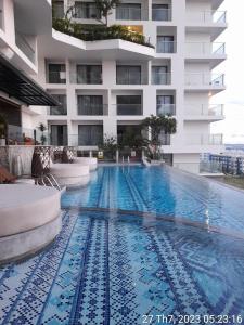 a large swimming pool in front of a building at Apec Mandala Phú Yên in Tuy Hoa