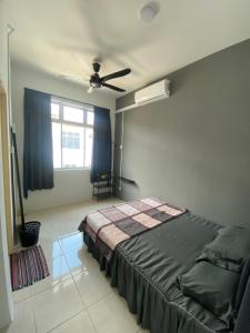 une chambre avec un lit et un ventilateur de plafond dans l'établissement Sara Villa @ 5mins A'famosa Resort, à Kampong Alor Gajah