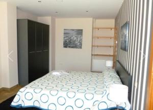 a bedroom with a bed with a polka dot blanket at Casa rural Puerta Villa in Villabrágima +29 photos