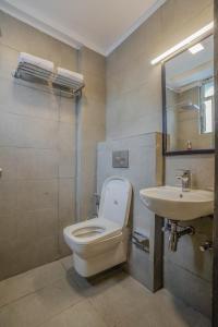 a bathroom with a toilet and a sink at SoonStay Konark Inn in Indore