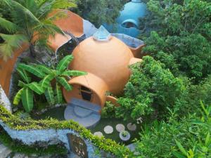 a model of a garden with an orange building at Jungle KingDomes Guest House in San Juan