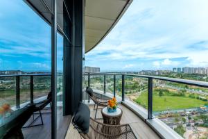 a balcony with a view of a city at Kew Green Hotel Mianshuicheng Haikou in Haikou