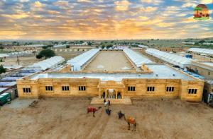 a large building with two horses in front of it at SAM DESERT RESORT in Sām