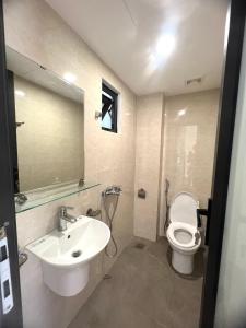 a bathroom with a sink and a toilet and a mirror at Era Apartment Trung Liet in Hanoi