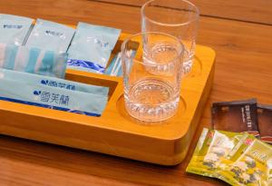 a wooden tray with a glass on top of it at 台中灣文旅 T C ONE Hotel in Taichung