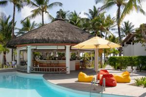 a swimming pool with a gazebo and yellow and red rubber shoes at Veranda Palmar Beach Hotel & Spa - All Inclusive in Belle Mare