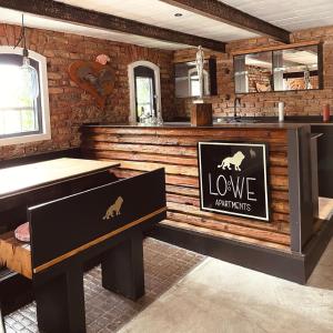 a bar with a bench and a sign that reads love portfolios at Löwe Apartments in Oy-Mittelberg