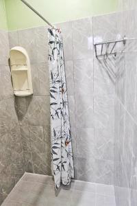 a shower in a bathroom with a shower curtain at Dome Resort SHA Plus in Kata Beach +21 photos