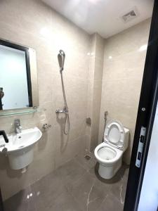 a bathroom with a shower and a toilet and a sink at Era Apartment Trung Liet in Hanoi