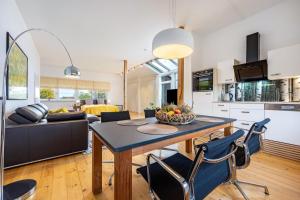 a kitchen and living room with a table and chairs at Landhaus Bleckede - App Lüneburg in Bleckede