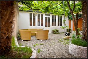 a patio with two chairs and a table at Hotel La Pergola di Venezia in Venice-Lido