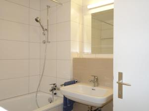 a bathroom with a sink and a shower at Laax Rancho Studio Apartment in Laax
