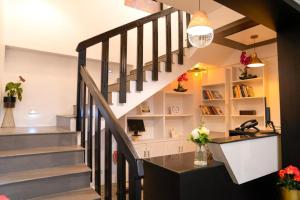 a staircase leading up to a home office with flowers at Namastay Leisure Homes in Kovalam