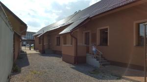 a row of buildings with a stairway to a building at Penzion Solna Jaskyna in Turčianske Teplice