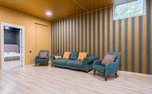 a waiting room with two chairs and a couch at Urban Villa By Umbrella in Tbilisi City