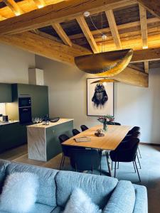 a dining room with a blue couch and a table at Hameau des Prodains - Résidence in Morzine +178 photos