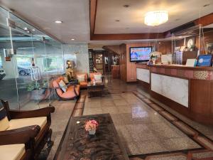 een lobby met banken en een televisie in een gebouw bij Interchange Tower Serviced Apartment - SHA Extra Plus in Bangkok