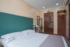 Postel nebo postele na pokoji v ubytování Hotel 28 Titiwangsa