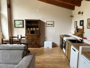 a kitchen with a couch and a table in a room at La casa sul fiume in Oulx
