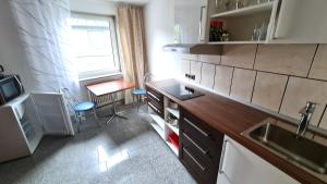 a small kitchen with a sink and a table at 50qm Flat am Uni Campus im Zentrum von Siegen in Siegen