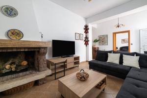 a living room with a couch and a fireplace at Olea Villa in Archipolis
