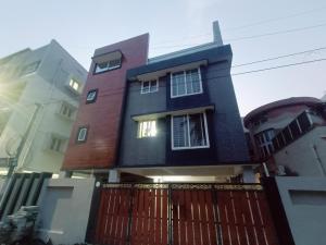 a house with a fence in front of it at Ananya service apartments in Chennai