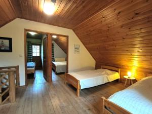 a large room with two beds and a mirror at Ulmenhof Melfsen in Oeversee
