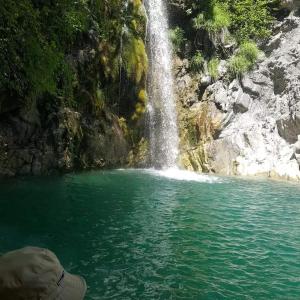 a waterfall in front of a body of water at Xenonas Zagorisio in Tsepelovo