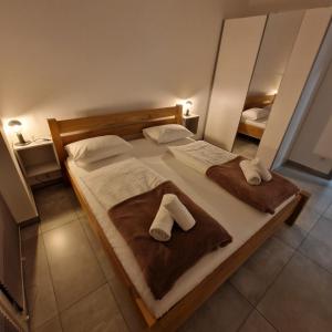 a bedroom with a large bed with towels on it at Apartamenty KADO (MATEJKI) in Karpacz