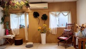 a living room with a chair and a vase of flowers at Huabing in Tainan