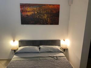 A bed or beds in a room at Room Mazzini