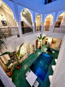 an indoor swimming pool in a building with plants at Riad Citrus in Marrakech