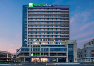 a tall building with a sign on top of it at Holiday Inn Express Mianyang Sci-Tech City, an IHG Hotel in Mianyang