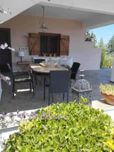 a patio with a table and chairs in a house at ZeusPlace Olympus Olive Country House 1 in Leptokarya