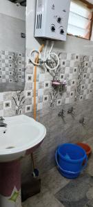 a bathroom with a sink and faucet at Raagabynature home stay in Gendehalli +85 photos