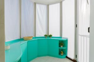 a room with a green cabinet and windows at Yourbanflat Monte Rosso in Teolo +30 photos