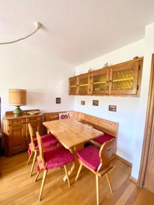 a dining room with a wooden table and chairs at FALORIA APARTMENT in Cortina dʼAmpezzo