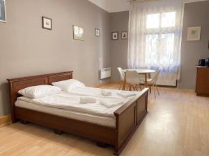a bedroom with a bed and a table with chairs at Freska Apartments in Lviv