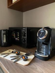 a coffee maker sitting on a counter next to a microwave at Freska Apartments in Lviv +14 photos
