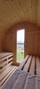 a wooden room with a bed and a window at Szczytowisko in Grywałd