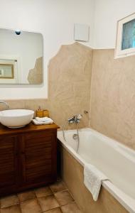 a bathroom with a sink and a tub and a mirror at Le Pavillon Vert - B&B in Vedène +37 photos