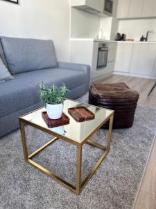 a living room with a couch and a coffee table at Apartmán s balkónom pri letisku na skok do centra mesta in Bratislava