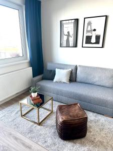 a living room with a couch and a coffee table at Apartmán s balkónom pri letisku na skok do centra mesta in Bratislava