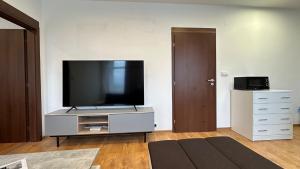 a living room with a flat screen tv on a entertainment center at 2 room Apartment - Apartmány Chopok in Liptovský Mikuláš