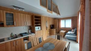 a kitchen and living room with a table and a couch at Apartmány U Potoka in Dolní Moravice