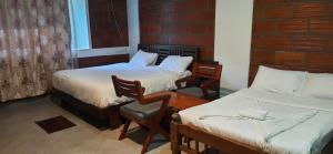 Postel nebo postele na pokoji v ubytování Coorg Vismaya Resort
