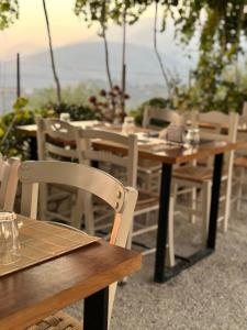a wooden table and chairs sitting in a restaurant at ELÉA Guesthouse himare in Himare