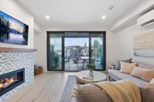 a living room with a couch and a fireplace at Coastal Haven at THE BEACH HOUSE in Campbell River