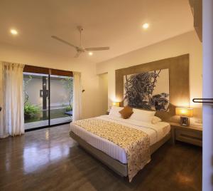 a bedroom with a bed and a large window at Serendiva Beach in Wadduwa